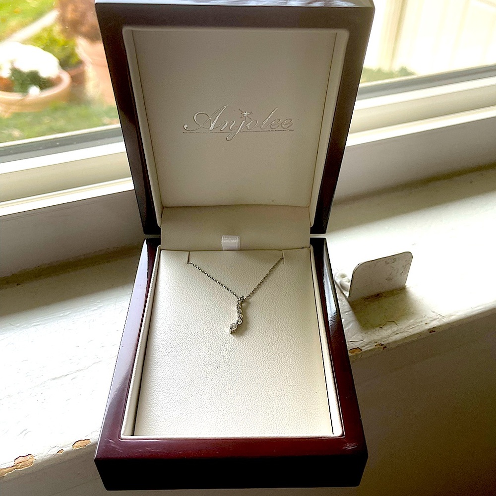 Brand new, white gold and diamonds.